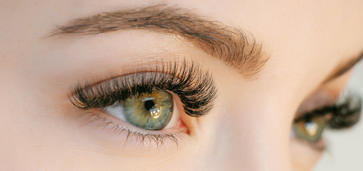 A close up of a woman's eyes with long lashes.