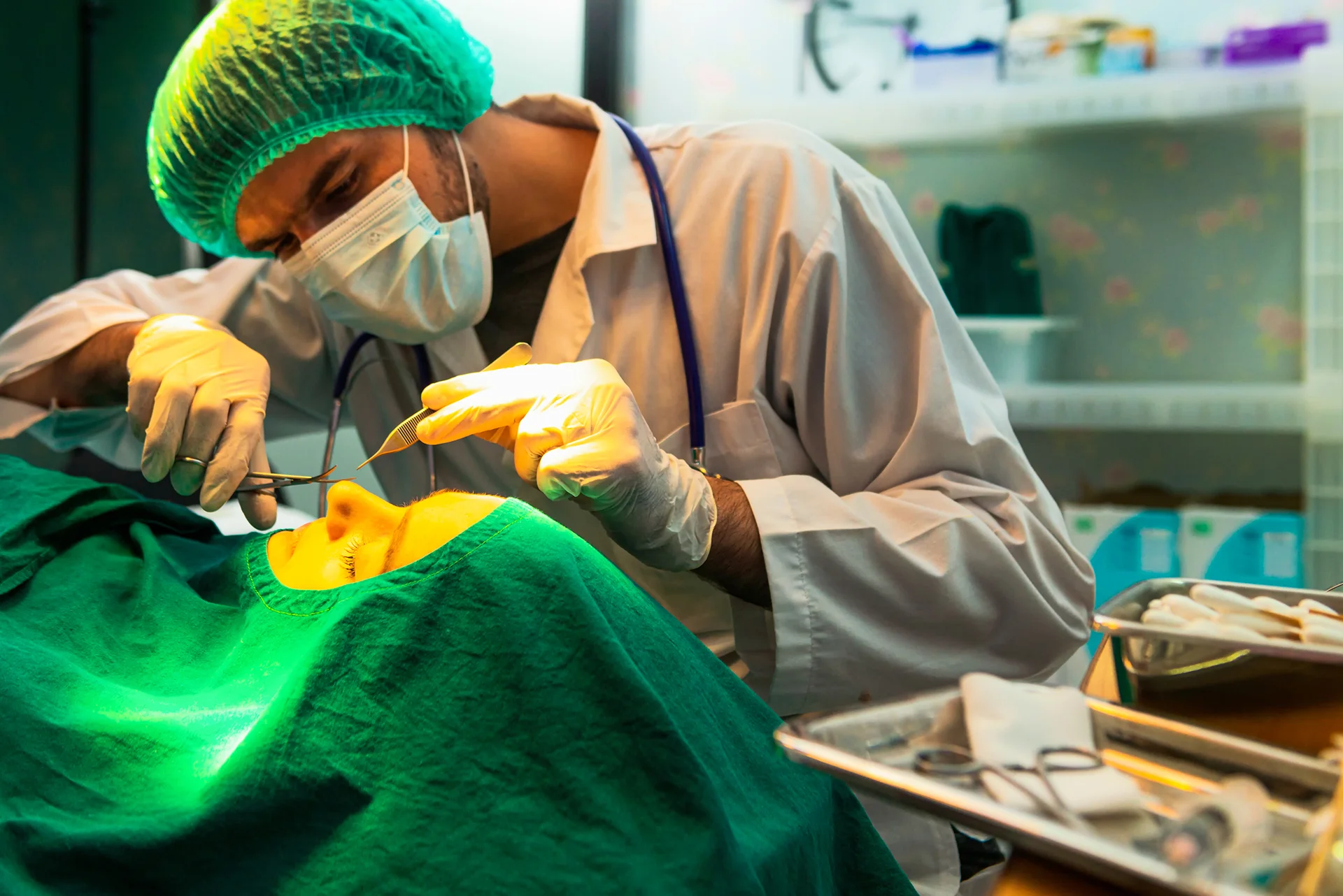 a surgeon performs surgery on a patient