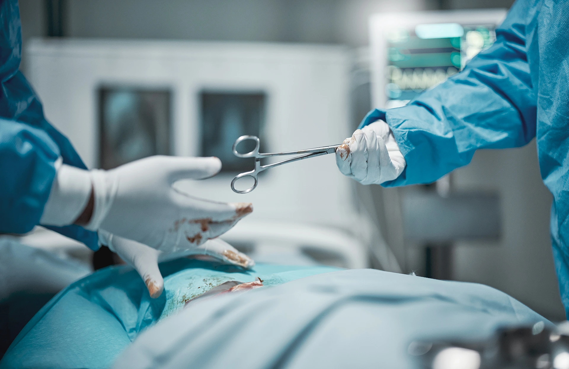 Two surgeons are working on a patient in an operating room.