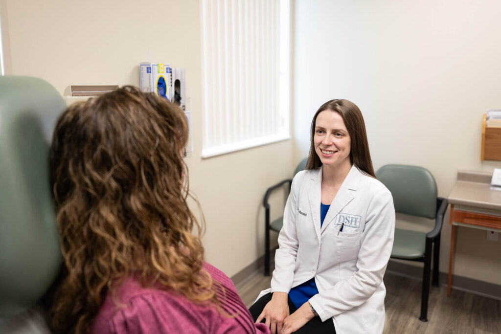 Dr. Plovanich helping a female patient