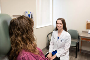 Dr. Plovanich helping a female patient