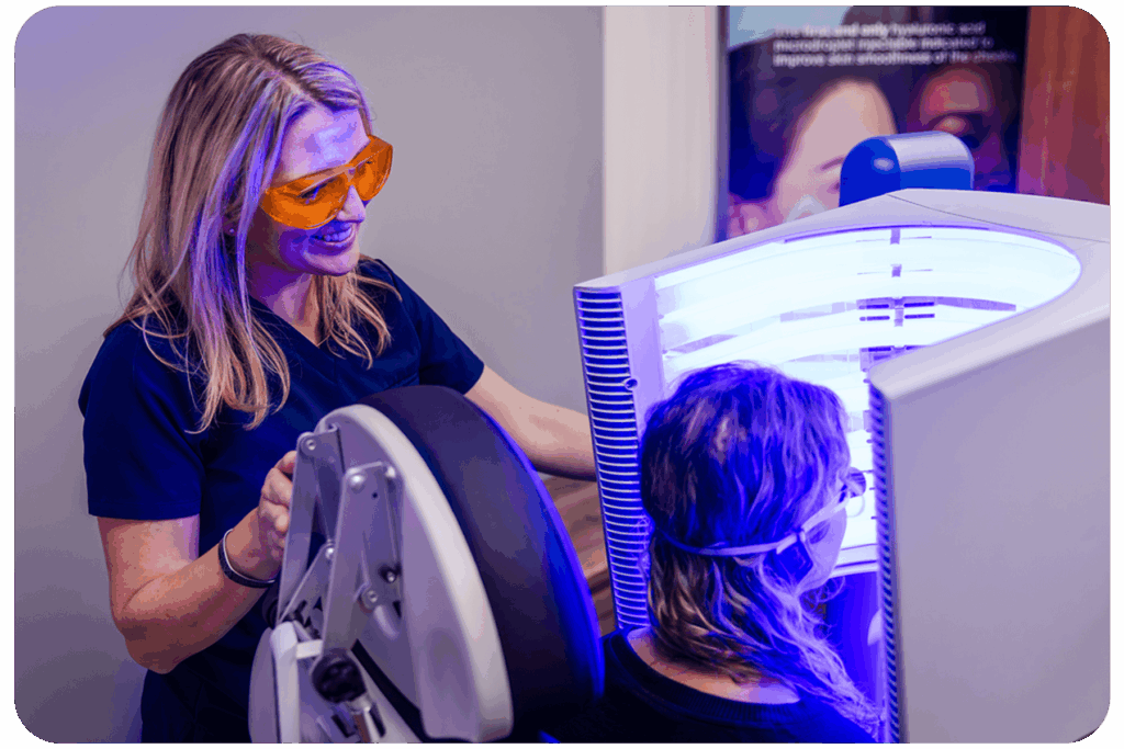 Medical assistant helping someone use the blue light therapy machine