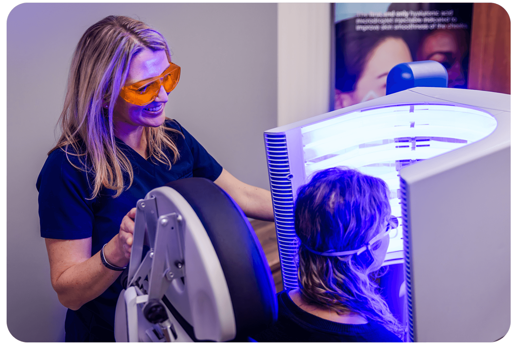 Medical assistant helping someone use the blue light therapy machine