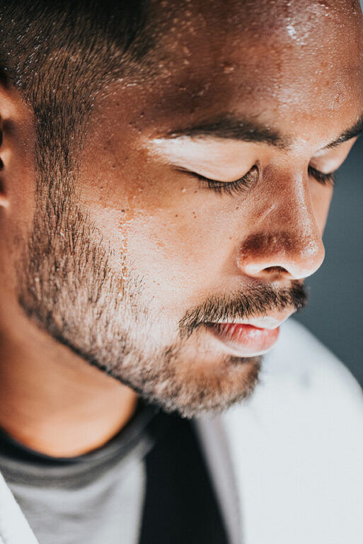 Man with sweat dripping down face