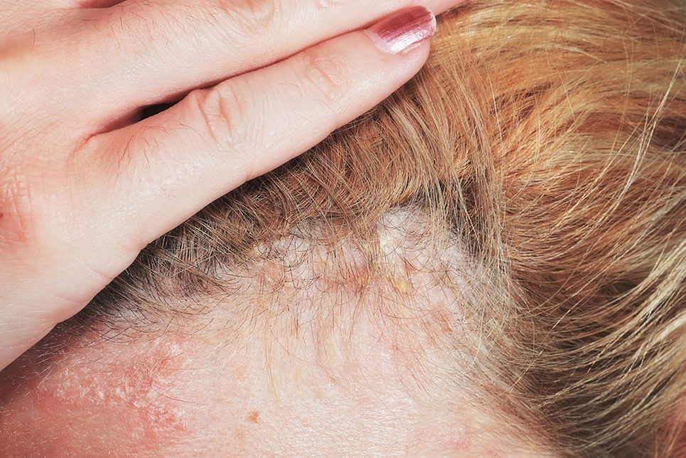 A woman is holding her hair with her hand.