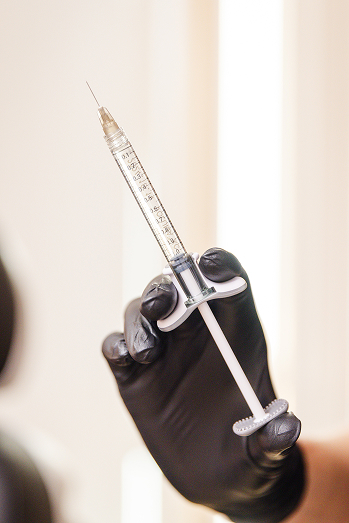 Someone holding a syringe filled with Botox®