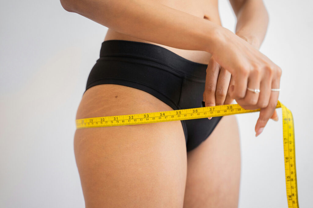 Person measuring their thighs
