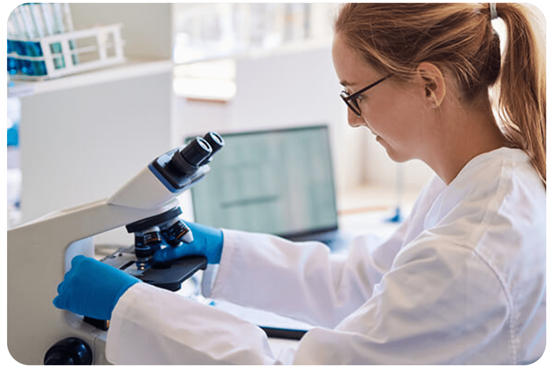Lab tech performing biopsy with microscope