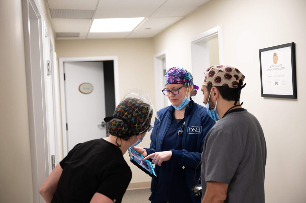 Dr mendese working with medical assistants