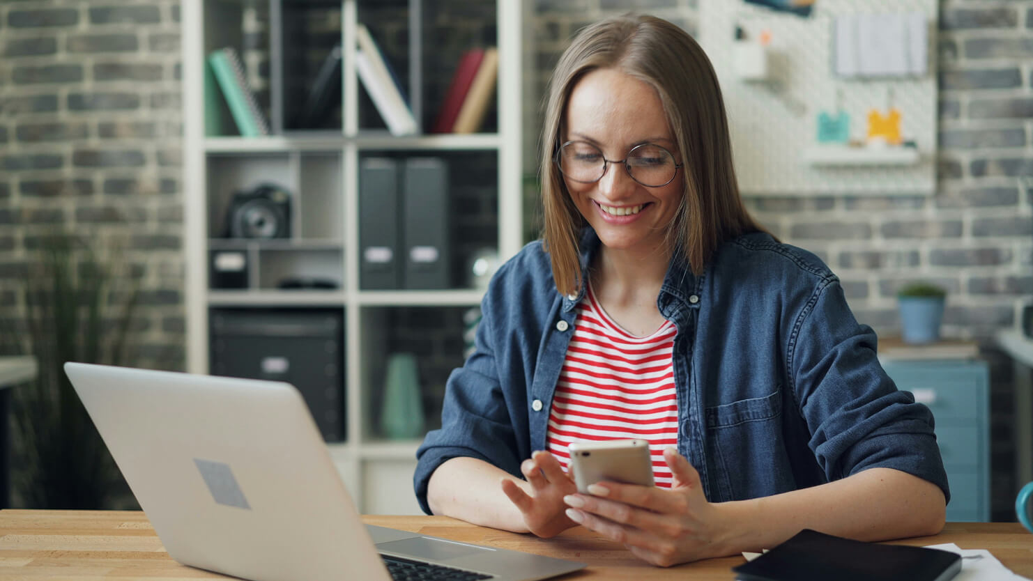 Person using phone and laptop